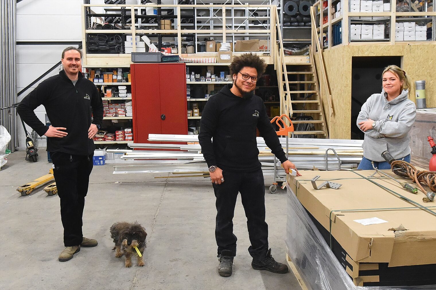 Dachdeckermeister Felix Moll mit seinen Mitarbeitern Arno Drews und Katharina Brüggemann in der großen Lagerhalle seines Betriebs